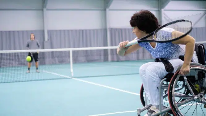 Woman in a wheelchair playing tennis