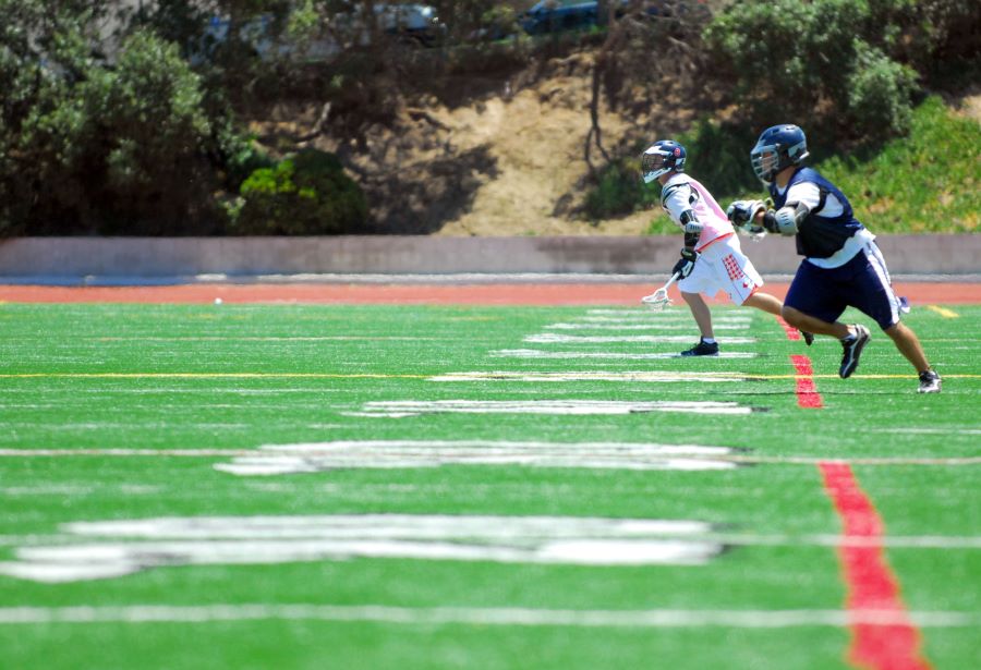 two lacrosse players running