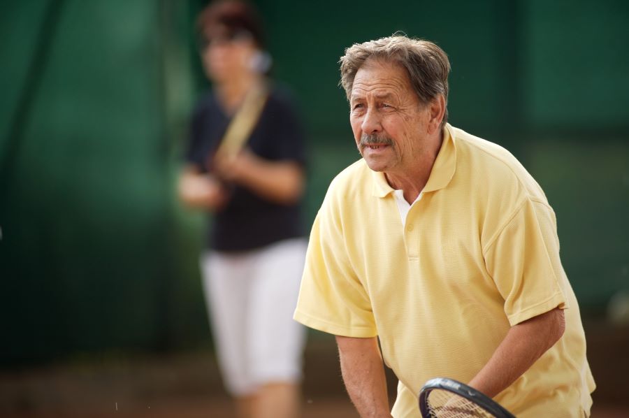 Senior man playing tennis