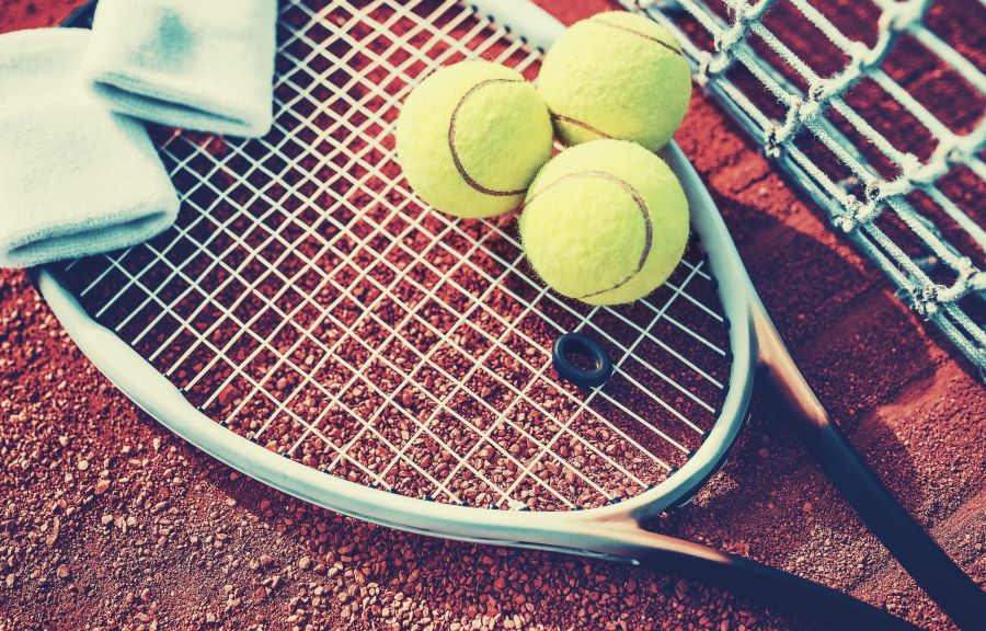 tennis racket with three tennis balls