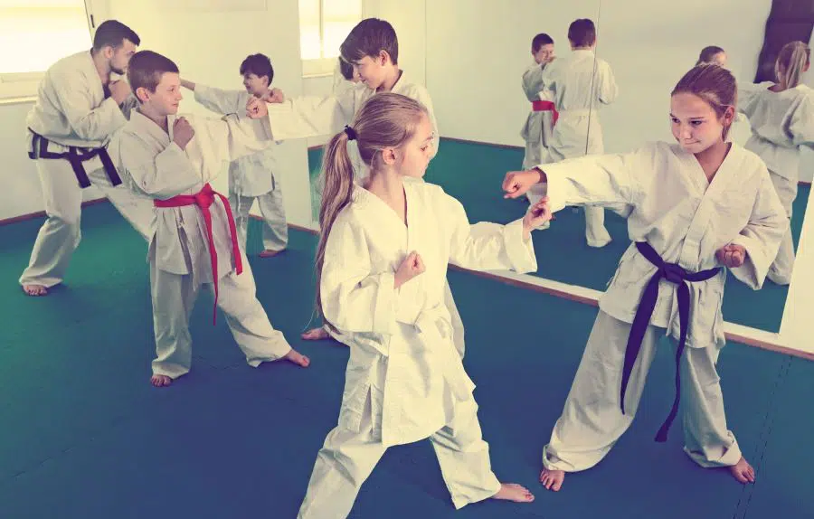 kids learning karate in a dojo