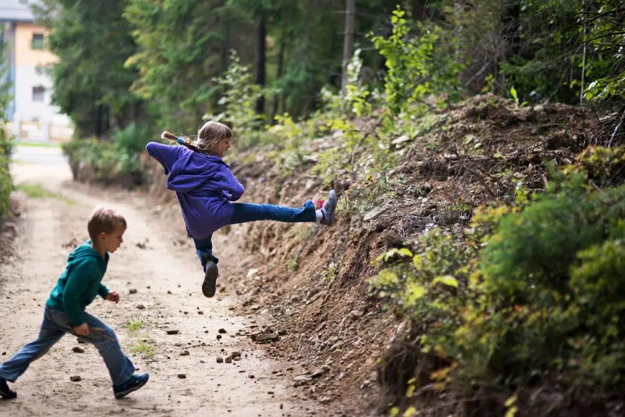 Kids trying karate moves out in the forest