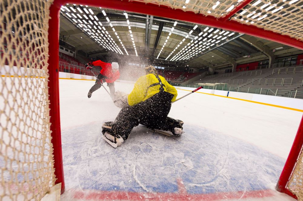 Hockey goalie trying to stop a close-up shot